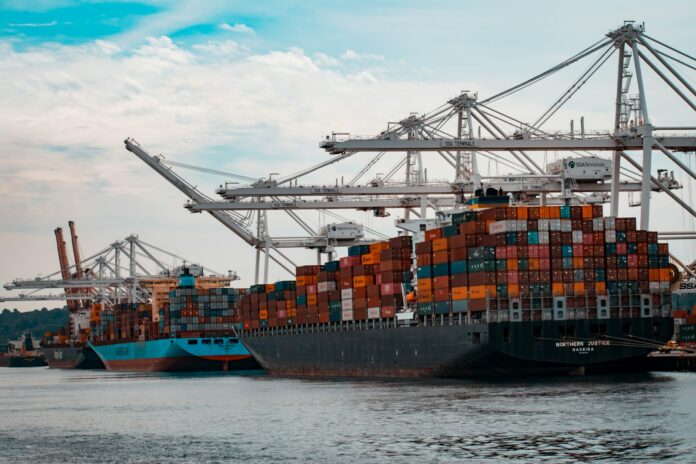 Photo by Andy Li cargo ships docked at the pier during day