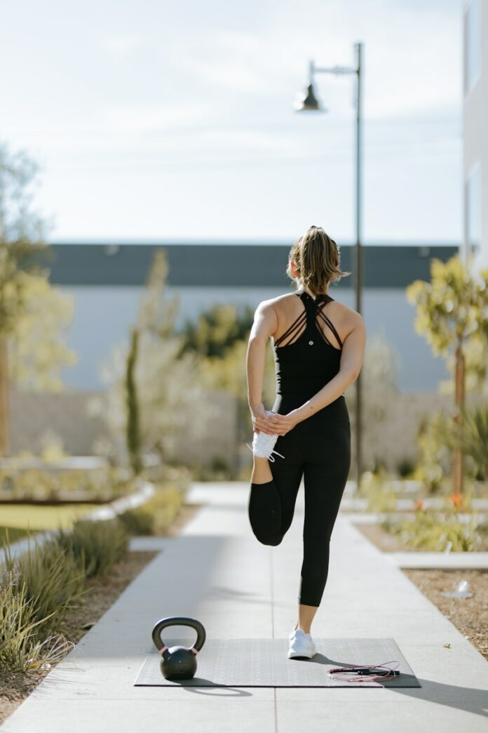 Photo by Josh Duke a woman is doing exercises on a yoga mat