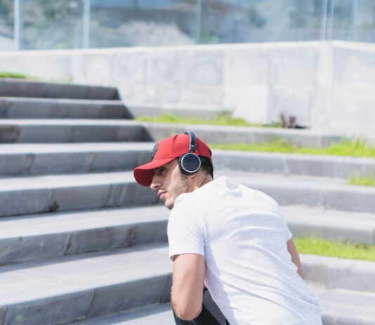 운동으로 예방하는 관절 질환: 근육 강화로 관절을 보호하기 man in white t-shirt and black and white pants wearing white sneakers sitting on concrete