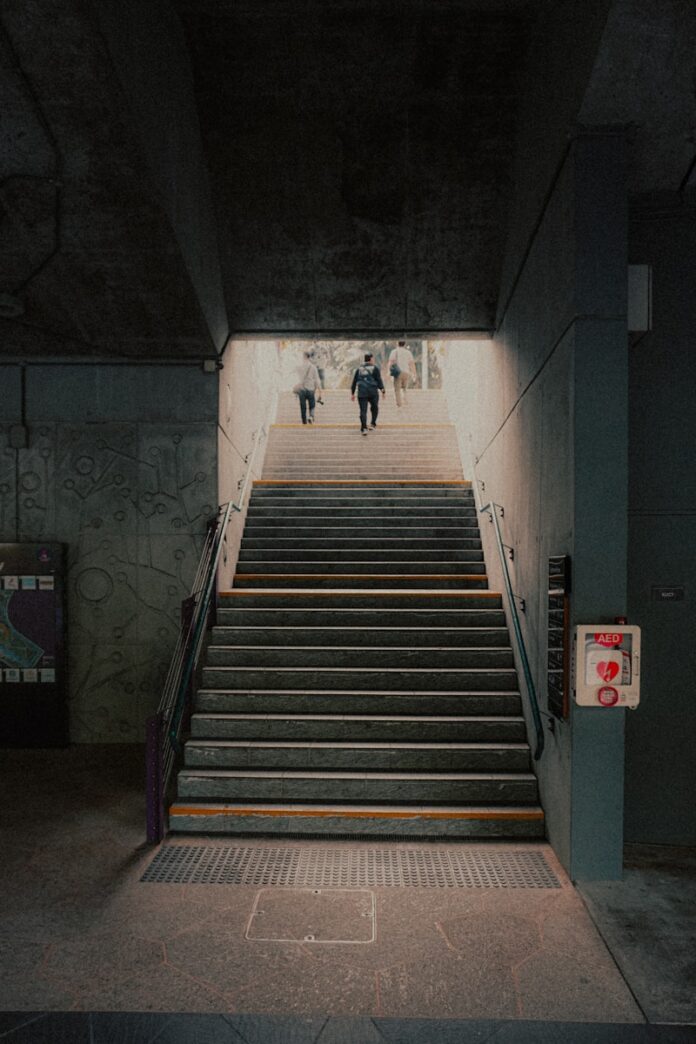 Photo by Daniel Yovanda A group of people walking down a flight of stairs