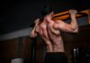 근육 건강, 일상에서 챙기는 ‘작은 습관’이 만든다 topless man in black shorts holding orange bar